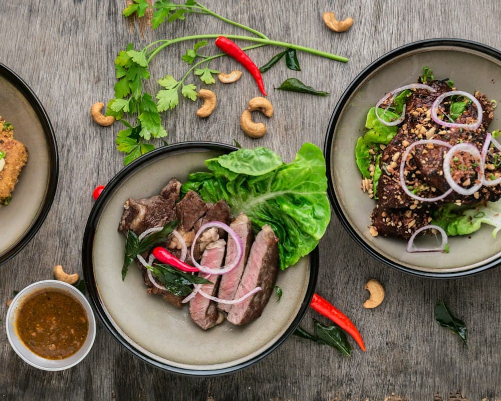Overhead view of several home-cooked dishes plated with fresh herbs